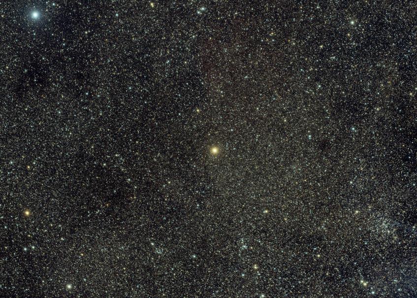 Ginan - Epsilon Crucis A bright orange star on a background that is dense with faint stars.