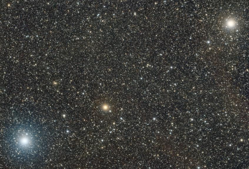 Unurgunite - Sigma Canis Majoris A bright orange star flanked by two even brighter white stars.